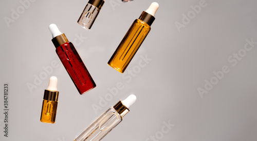 Natural hyaluronic serums flying. Natural materials and skin care concept. Horizontal view copyspace.