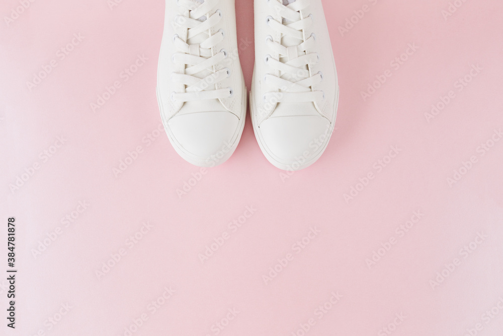 Pair of fashion stylish white sneakers, Running sports shoes on pastel pink background. Pair of fashion stylish white sneakers, Running sports shoes on pastel pink background.