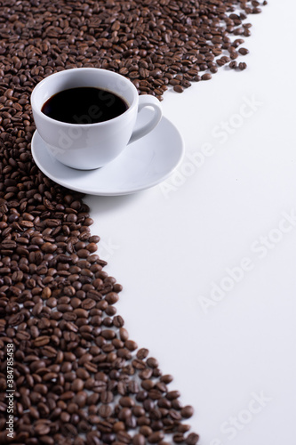 Fototapeta Naklejka Na Ścianę i Meble -  CUP OF COFFEE AND COFFEE BEANS ON WHITE BACKGROUND, SPACE FOR TEXT
