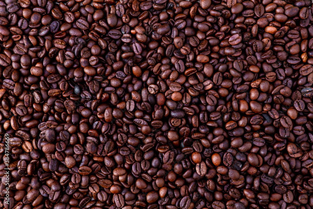 Freshly roasted coffee beans background. Coffee beans background. Background of roasted coffee beans. Freshly roasted coffee beans background. Coffee beans background. Background of roasted coffee beans.