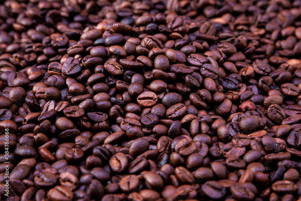 Freshly roasted coffee beans background. Coffee beans background. Background of roasted coffee beans. Freshly roasted coffee beans background. Coffee beans background. Background of roasted coffee beans.