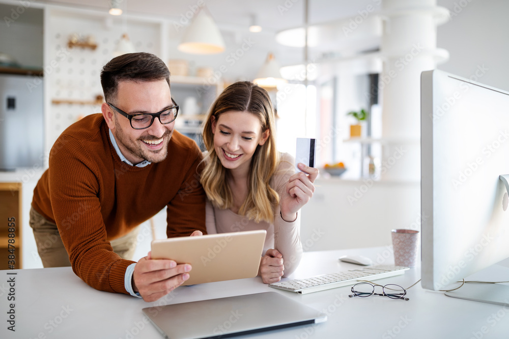Portrait of a cheerful couple shopping online. Technology, e-commerce, banking concept Portrait of a cheerful couple shopping online. Technology, e-commerce, banking concept