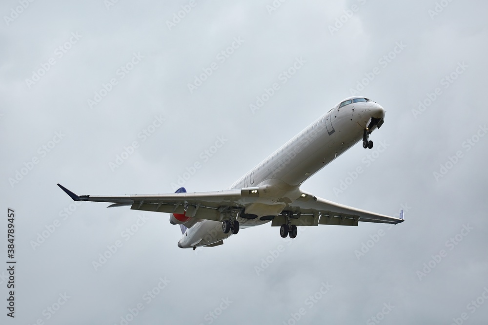 Plane approaching landing in cloudy overcast weather Plane approaching landing in cloudy overcast weather