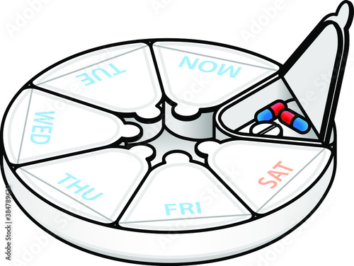 A round weekly medication/pill box marked with day names. Shown with one compartment opened with pills inside.