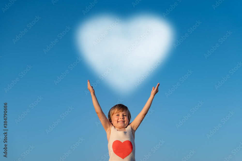 Happy child holding cloud against blue sky Happy child holding cloud against blue sky