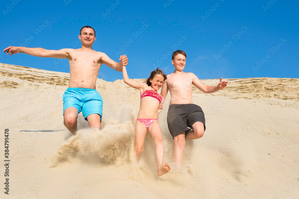 Family beach games on the beach on a sunny day. The family runs on the sand, vacation, vacation. Family beach games on the beach on a sunny day. The family runs on the sand, vacation, vacation.
