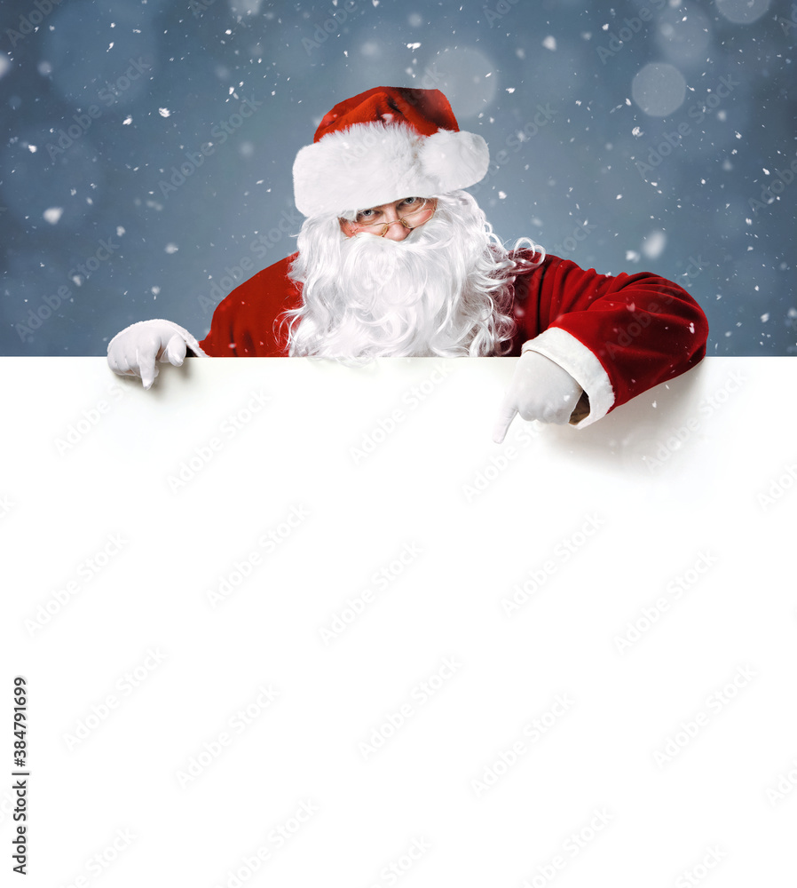 Happy Santa Claus pointing in blank white advertisement banner with copy space Happy Santa Claus pointing in blank white advertisement banner with copy space
