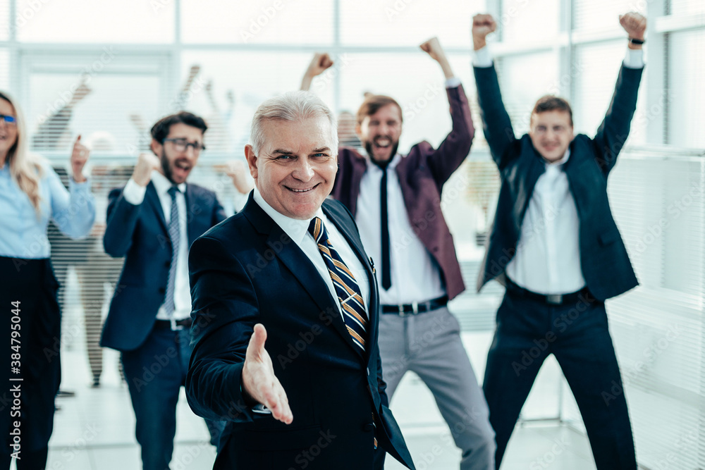 happy businessman holding out his hand for a handshake. happy businessman holding out his hand for a handshake.