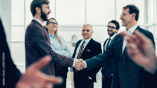 confident business people shaking hands with each other.
