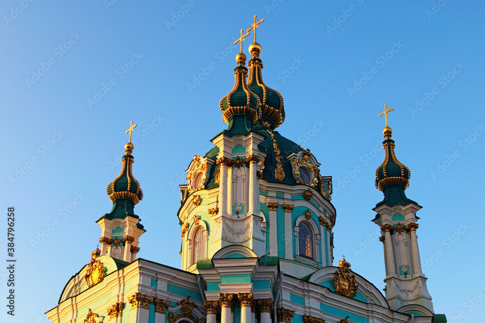 Astonishing detailed view of ancient Saint Andrew Church against blue sky at sunny spring morning. Baroque style in ancient architecture. Architectural icon of the city of Kyiv, Ukraine