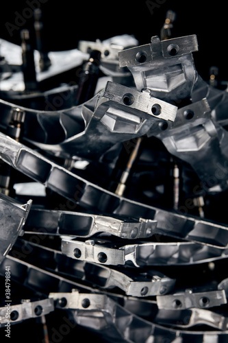 Close-up view of stainless steel hardware components on black background