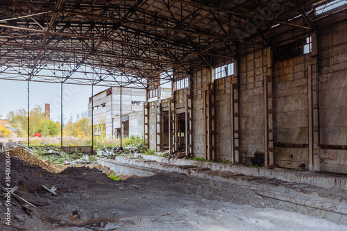 Abandoned ruined large industrial hall with garbage waiting for demolition