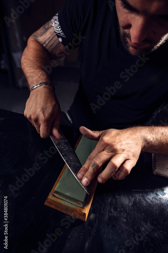 Man sharpening the knife