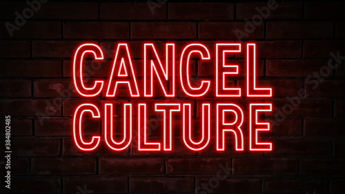 Cancel culture - red neon light word on brick wall background