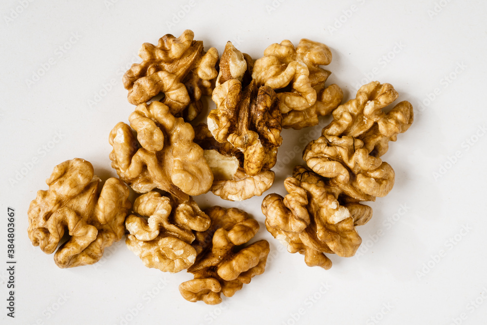 Pile of walnut halves on white background Pile of walnut halves on white background