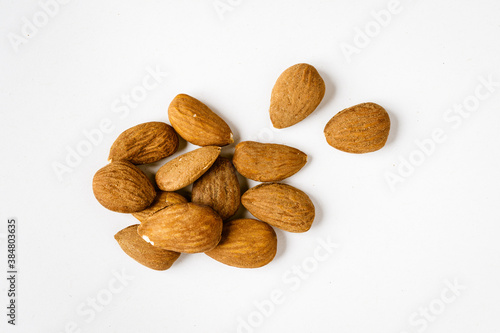 Pile of raw almonds on white background