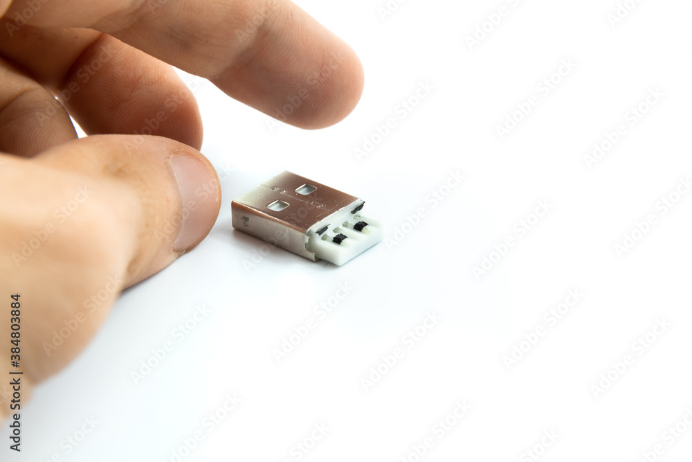 Broken cable USB connector man hand on white isolated background Broken cable USB connector man hand on white isolated background