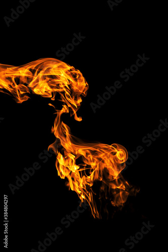 Fire flames on black background isolated. Burning gas or gasoline burns with fire and flames. Flaming burning sparks close-up, fire patterns. Infernal glow of fire in the dark with copy-space © NataliSam