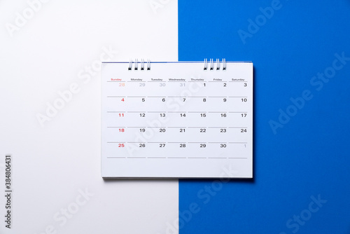 close up of calendar on the white and blue table, planning for business meeting or travel planning concept