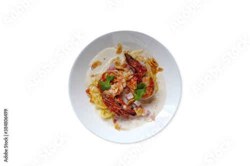 spaghetti carbonara cheese with shrimps , prawns and bacon in the white plate is isolated on white background