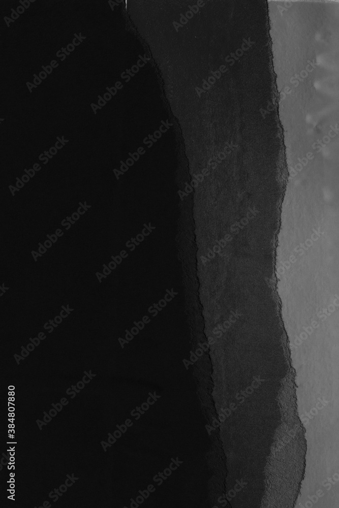 Black torn paper collage close-up. Texture made from various paper and cardboard parts. Damaged old paper background. Vintage blank wallpaper. Material design backdrop. Black torn paper collage close-up. Texture made from various paper and cardboard parts. Damaged old paper background. Vintage blank wallpaper. Material design backdrop.