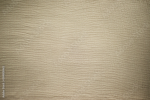Fabric texture. Beige multi-layered muslin background for different designs. Textile theme.