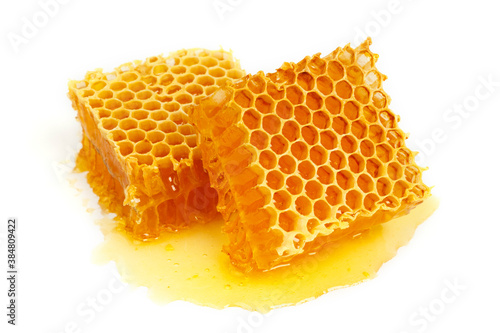 Bee combs with honey isolated on a white background. A flowing sweet dessert. A portion of a healthy and healing treat.