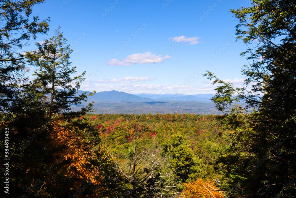 beautiful fall colors in a New York state park with the Catskill Mountains in the background 
