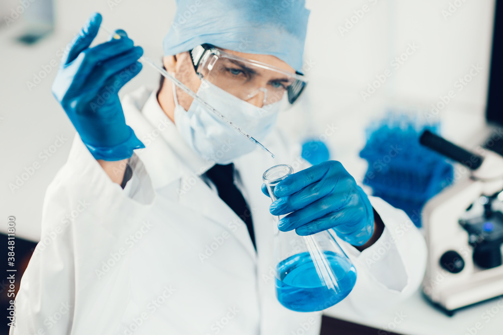 close up. scientist studying the liquid in a medical flask. close up. scientist studying the liquid in a medical flask.