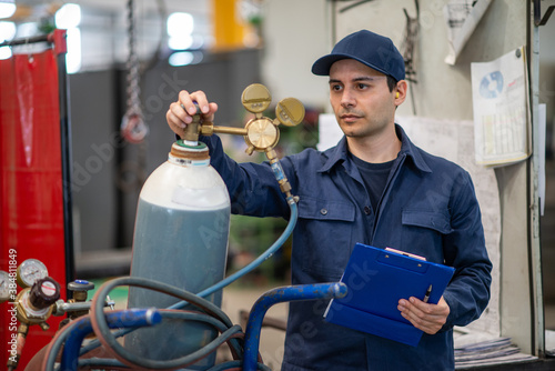 Tableau sur toile Inspector checking a gas tank in a factory