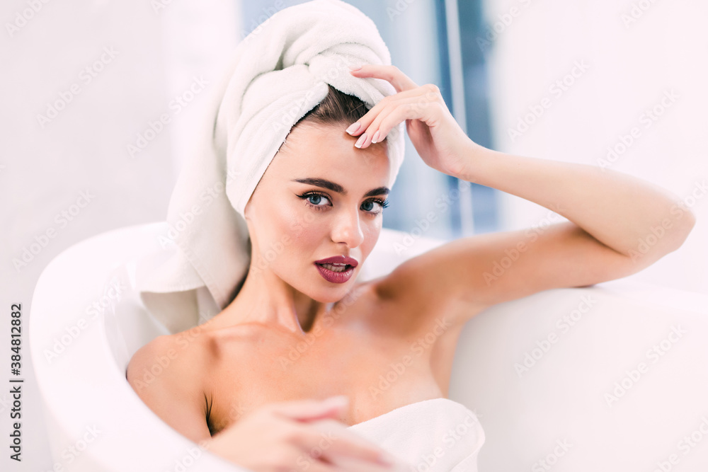 Young woman taking a bath with a towel on her head. Beauty concepts Young woman taking a bath with a towel on her head. Beauty concepts