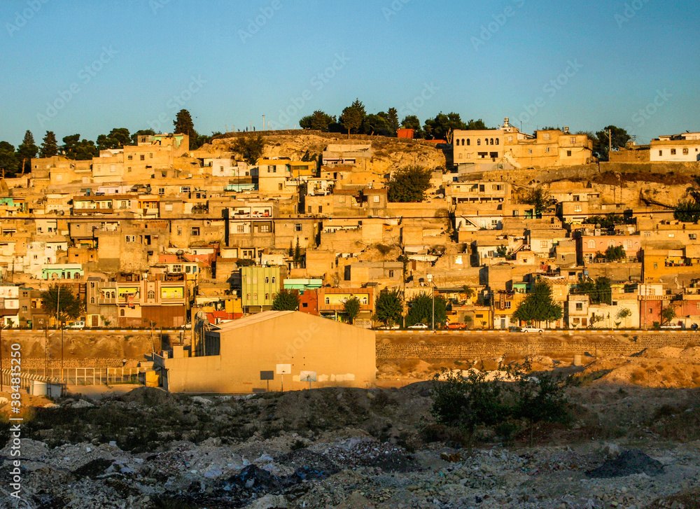 Obraz premium City town buildings with old facade and tumbledown neighborhood in middle east with yellow sunset