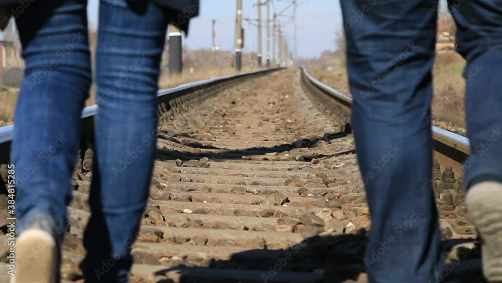 Man and woman walking on the railroad Man and woman walking on the railroad