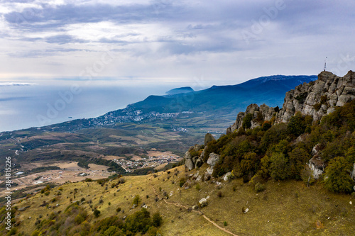 a panoramic view of the beautiful mountains with unusual ledges and rocks against the background of the sky and the valley filmed from a drone