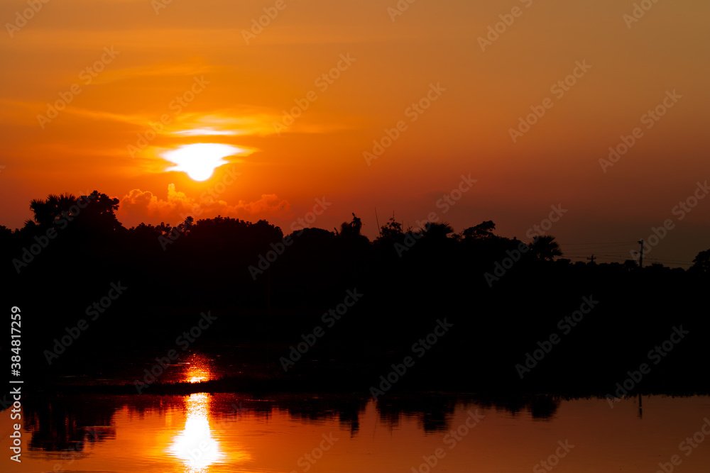 A beautiful golden sunset over the lake in the village