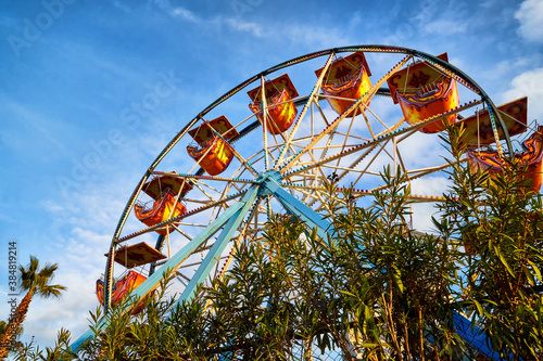 Antalya  Turkey - December 21  2019  Ferris wheel against a blue sky in the green park