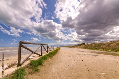 Seascape - Footpath with fence and cloudy sky