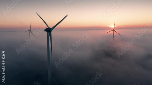 Wallpaper Mural Wind turbine at sunrise in heavy fog. Wind farm generating green energy Torontodigital.ca