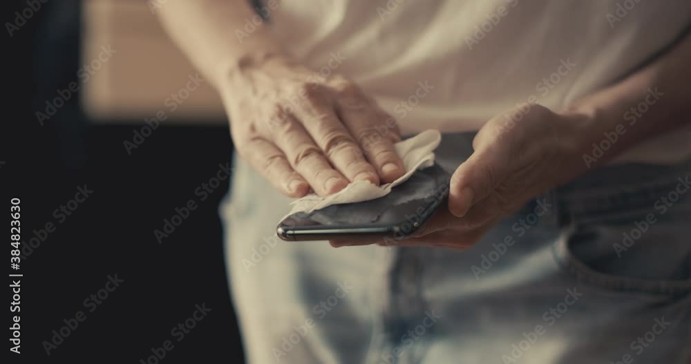 Wiping mobile phone with a wet napkin Wiping mobile phone with a wet napkin