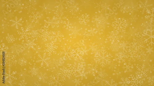 Christmas background of snowflakes of different shapes, sizes and transparency in yellow colors