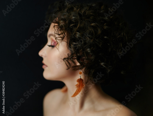 Profile portrait of curly brunette woman