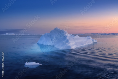 floating glaciers in the rays of the setting sun at polar night