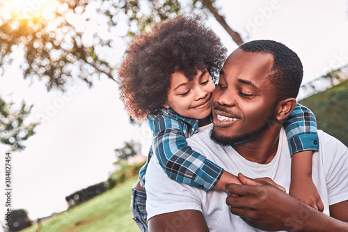 Curly happy kid giving his father cute big hug © Afshar Tetyana