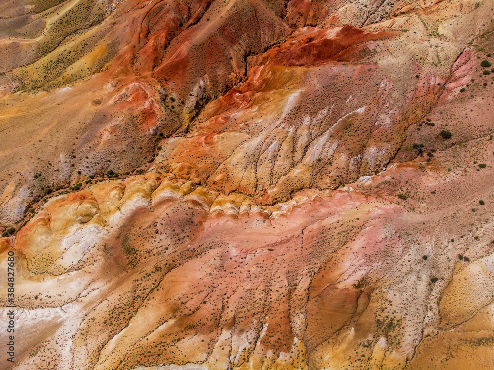 Aerial drone view of the textured yellow and red mountains resembling the surface of land, nature landscape in popular tourist location called Mars, near the border with Mongolia, Chagan-Uzun, Altai