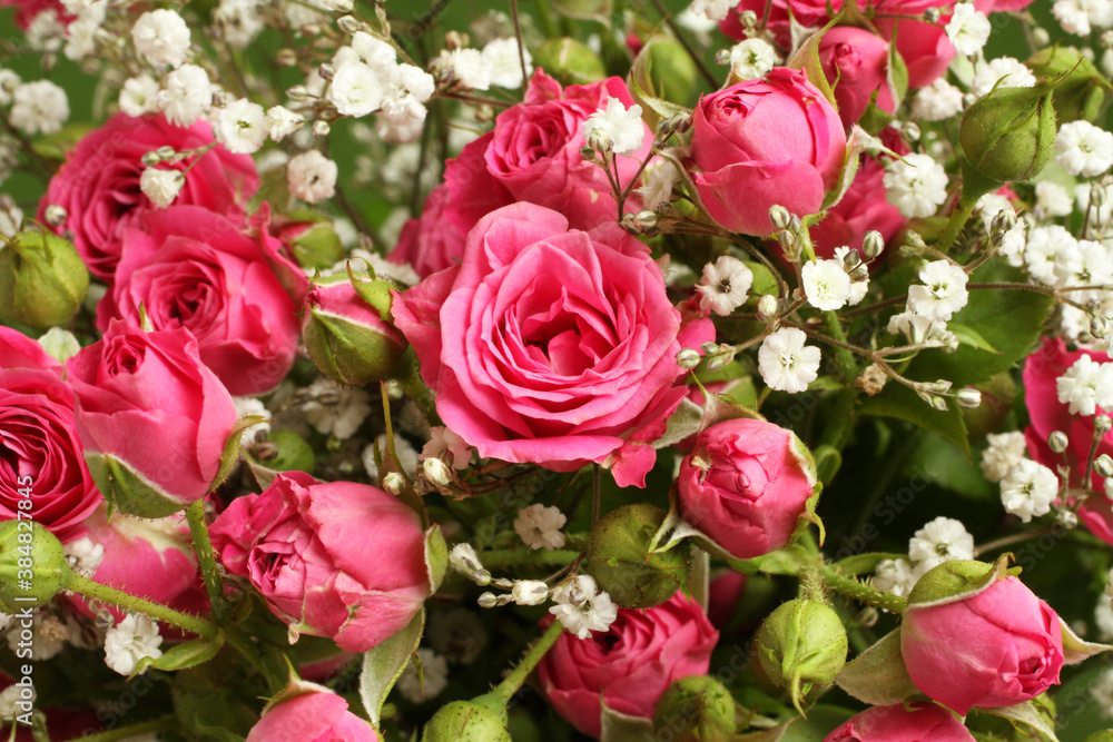 Bouquet of small pink roses on a green background. Closeup Bouquet of small pink roses on a green background. Closeup