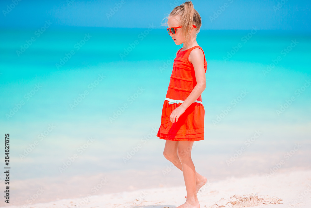 Cute little girl at beach during caribbean vacation Cute little girl at beach during caribbean vacation