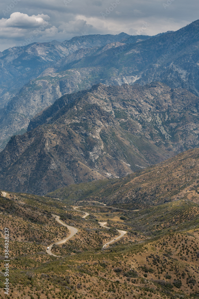 A view of the famous Kings Canyon 50-mile Byway and mountains within Kings Canyon National Park, California. A long twisting and turning road.