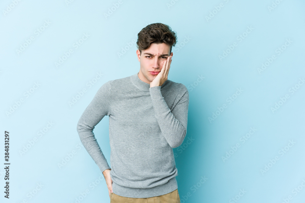 Young caucasian man isolated on blue background who feels sad and pensive, looking at copy space. Young caucasian man isolated on blue background who feels sad and pensive, looking at copy space.
