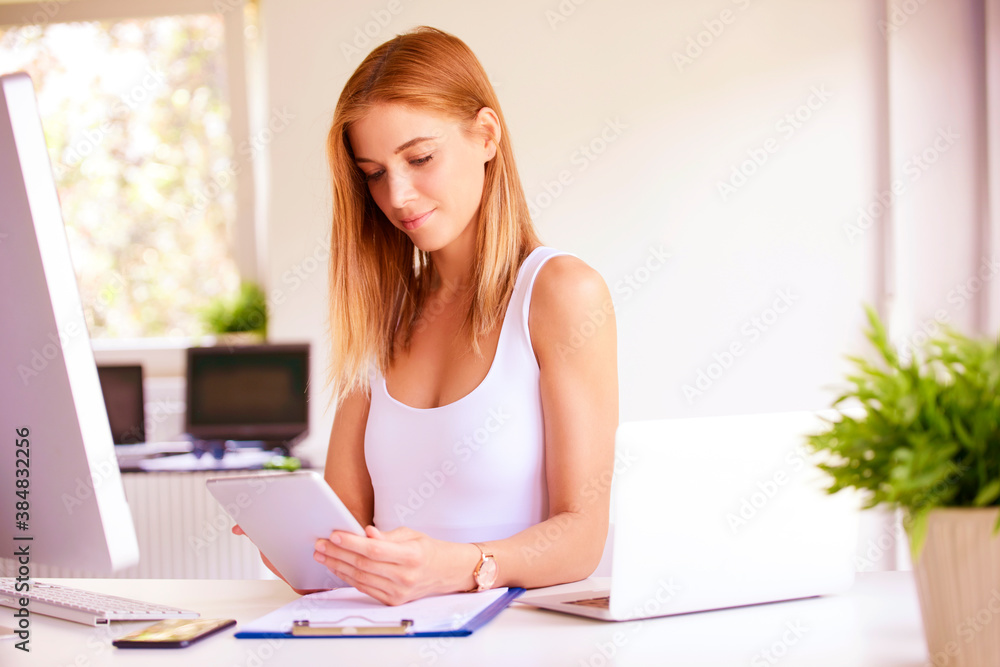 Fototapeta premium Sales woman holding touchpad in her hand