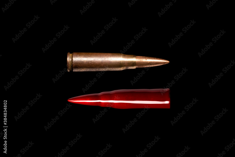 Two rifle bullets isolated on black background. Bloody bullet. Symbol of war, suffering, murder and crime. Two rifle bullets isolated on black background. Bloody bullet. Symbol of war, suffering, murder and crime.